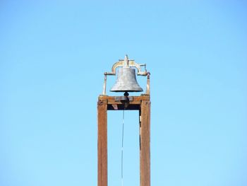 Low angle view of bell tower against blue sky