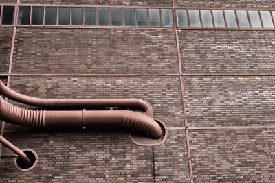 Low angle view of pipes on industrial building