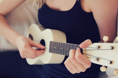 Cropped image of man playing guitar