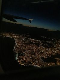 Aerial view of cityscape against sky at night