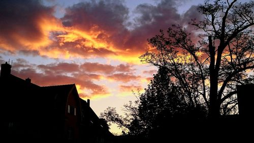 Silhouette of building against dramatic sky