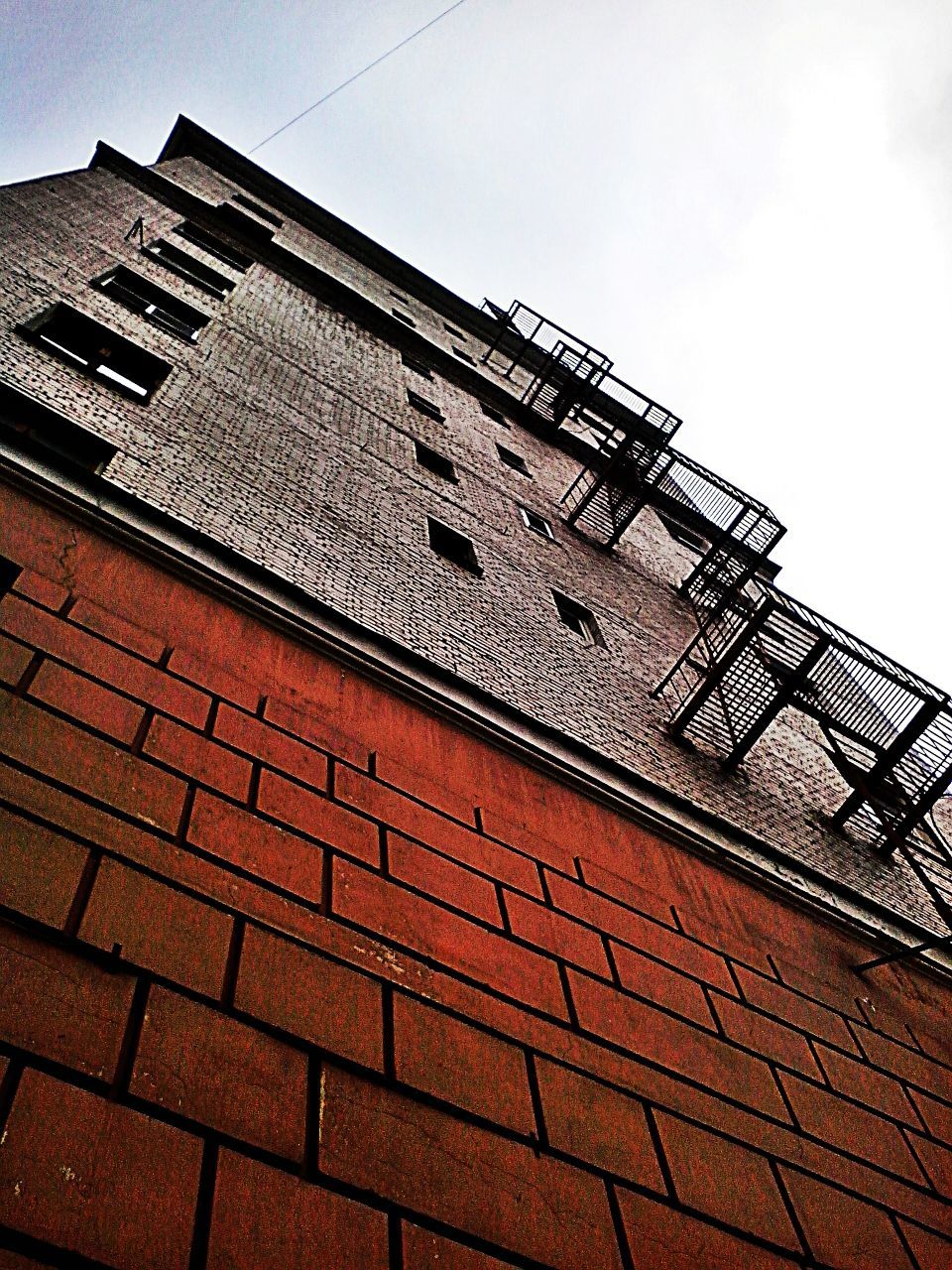 architecture, built structure, low angle view, building exterior, brick wall, sky, window, old, building, wall - building feature, day, outdoors, steps, no people, brick, staircase, clear sky, pattern, steps and staircases, sunlight