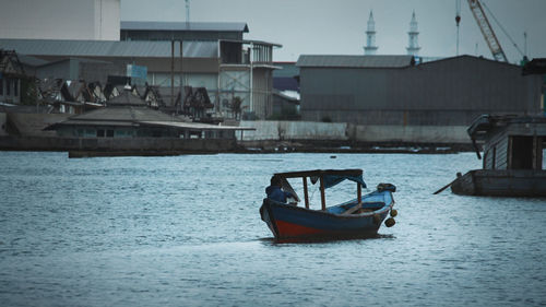 Boat sailing in river against sky