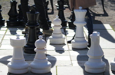 Low section of people standing at chess floor