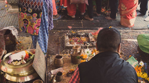 Rear view of people standing outside temple