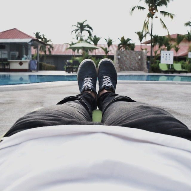 low section, shoe, person, personal perspective, footwear, lifestyles, jeans, focus on foreground, relaxation, street, sitting, selective focus, standing, day, human foot, building exterior, outdoors