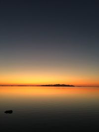 Scenic view of sea against clear sky during sunset