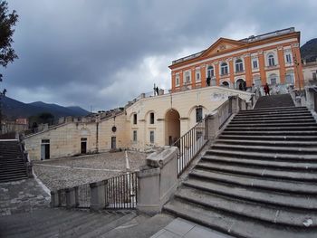 Old building in town against cloudy sky