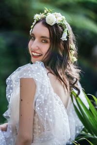 Portrait of a smiling young woman against blue sky