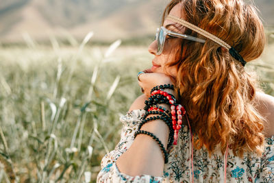 Close-up of woman looking away on land