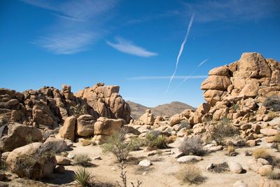 Scenic view of mountains against blue sky