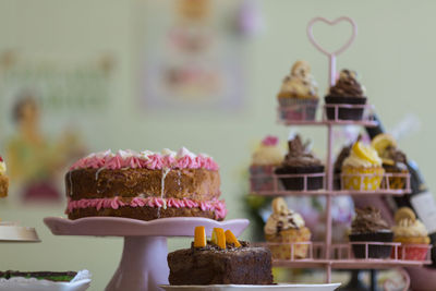 Close-up of cakes on stand indoors