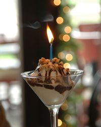 Close-up of lit candle in ice cream