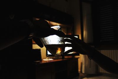 Close-up of hand pouring tea cup