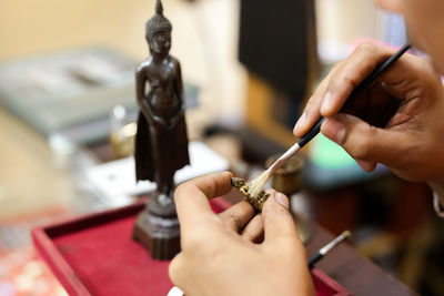 Close-up of hand holding painting