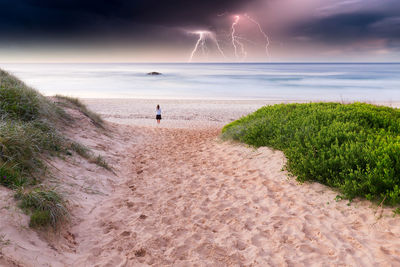 Mid distance of woman walking at beach