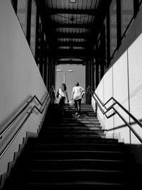 Low angle view of women moving up steps