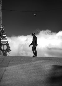 Low angle view of man walking on street