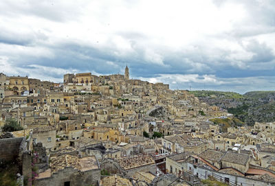 Aerial view of townscape against cloudy sky