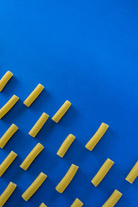 Close-up of yellow buttons against blue background