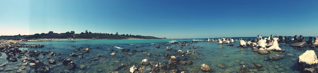 Panoramic view of beach against blue sky