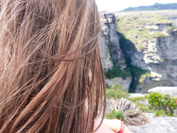 Cropped image of woman with brown hair on mountain