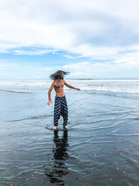 Man standing on beach against sky