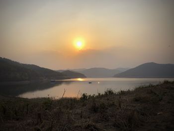 Scenic view of lake against sky during sunset