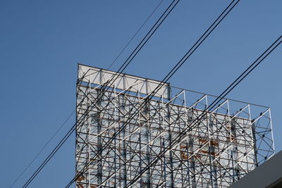 Low angle view of crane against clear sky