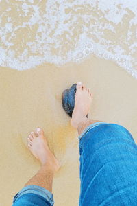 Low section of man feet on sand