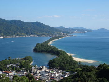 High angle view of sea and mountains against sky