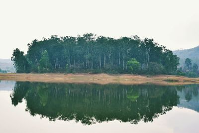 Reflection of trees in lake against sky