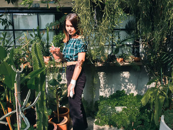 Full length of woman holding plants