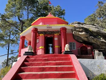 Low angle view of red building against sky