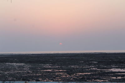 Scenic view of sea against clear sky during sunset