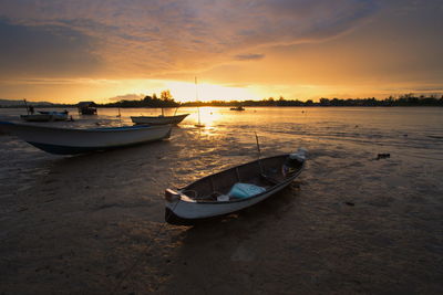 Boat in sea at sunset