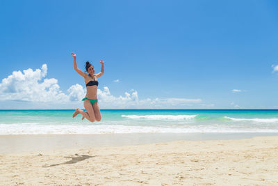 Pretty young woman enjoying on the beach in fuerteventura, canary islands, spain.