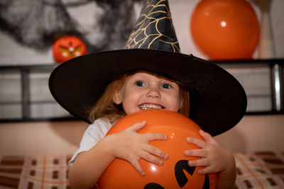 Cute smiling girl wearing hat sitting at home