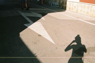 Low section of person shadow on tiled floor