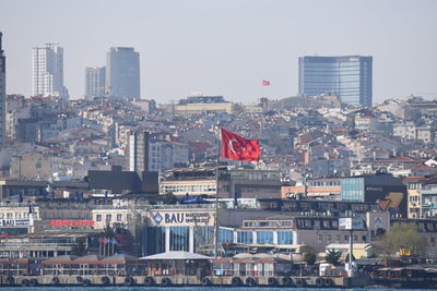 Buildings in city against clear sky