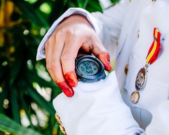 Midsection of soldier wearing wristwatch