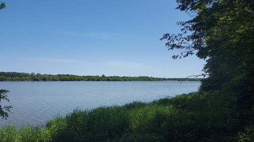 Scenic view of lake against blue sky