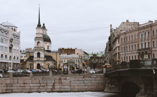 Buildings in town against sky in city