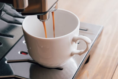 Espresso coffee preparation on a wooden table