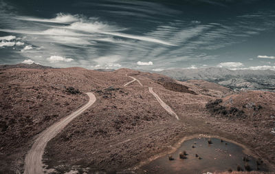 High angle view of road amidst land against sky