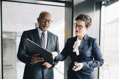 Senior businesswoman explaining strategy to colleague in conference room at office