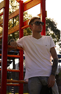 Portrait of young man standing against built structure