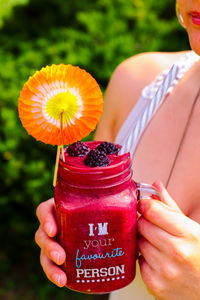 Midsection of woman holding fruit