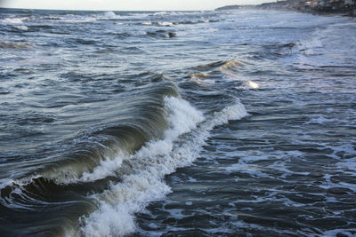 High angle view of waves rushing towards shore