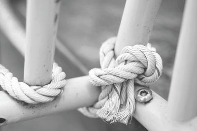 Close-up of rope tied on railing